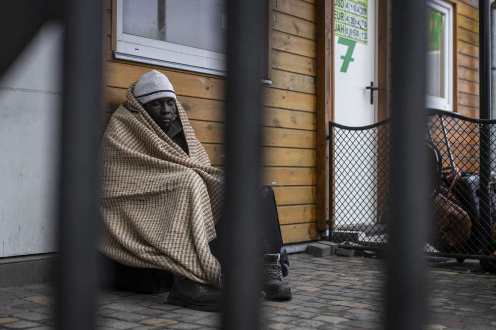 An African man rests as refugees from many countries - Africa, the Middle East and India - mostly students of Ukrainian universities are at the Medyka pedestrian border crossing fleeing the conflict in Ukraine, in eastern Poland